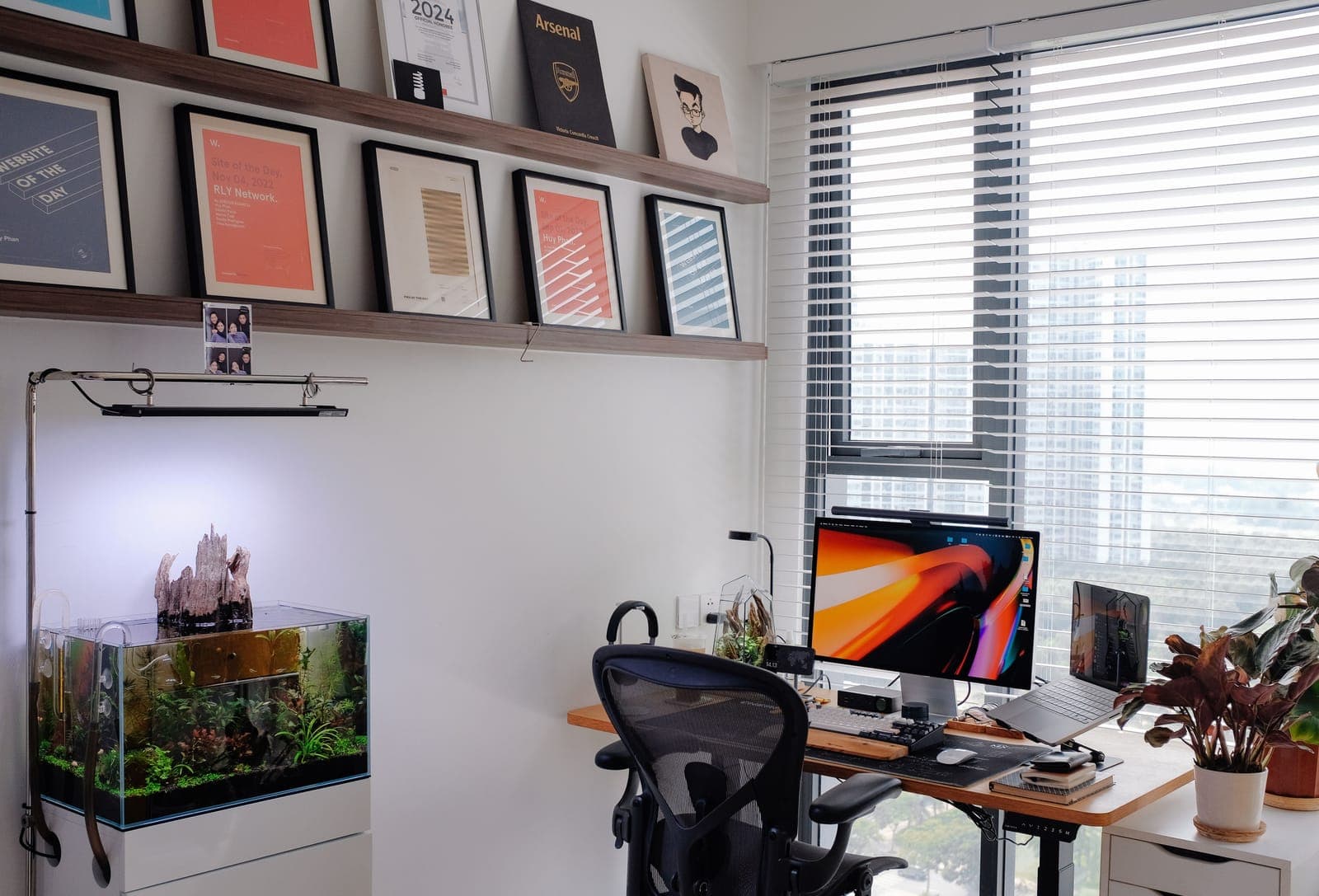 A planted aquarium on a cabinet in a clean office